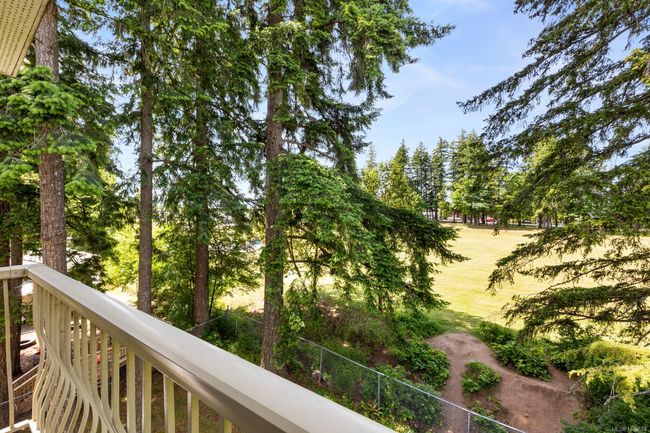 Balcony featuring view of wooded area | Image 5