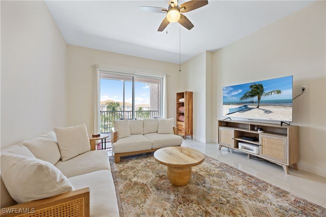 Tiled living room with ceiling fan and baseboards | Image 23