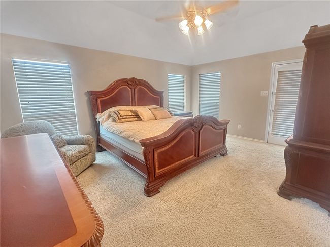 Bedroom with light carpet, a ceiling fan, and baseboards | Image 6