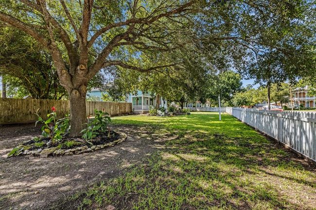 Lot is completely fenced with picket fence in the front and privacy fence in the back. | Image 24