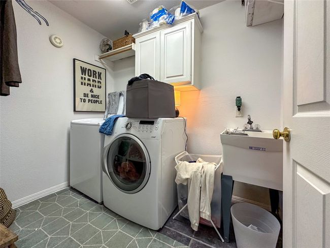 Washroom featuring washer and dryer and cabinet space | Image 21