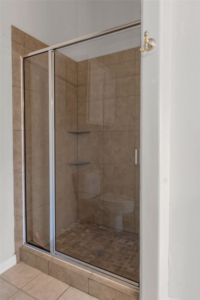 Full bathroom with a stall shower and tile patterned floors | Image 26