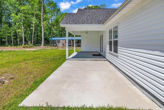 View of patio with ceiling fan and a carport | Image 34