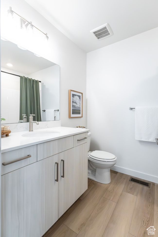 Full bath with vanity, wood finished floors, and a shower with curtain | Image 24