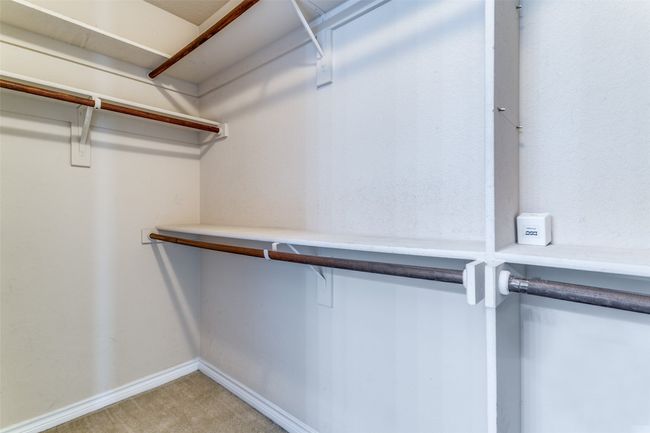The primary closet has plenty of room to hang all of your clothes. | Image 23