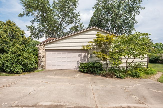 garage featuring driveway | Image 33