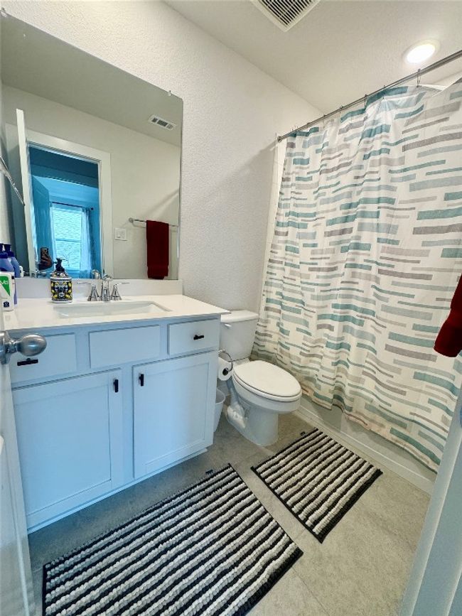 Full bathroom featuring toilet, vanity, and shower / bathtub combination with curtain | Image 24
