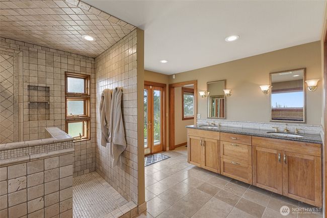2 headed shower with tumbled marble and a granite bench. | Image 19