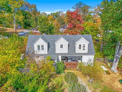 Rear view of property with a wooden deck | Image 1