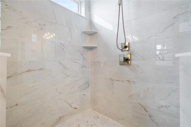 Large tiled shower with rain-head and hand-held shower heads. | Image 26