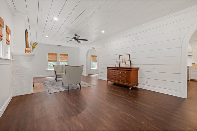 Dining room with arched walkways, wood finished floors, ceiling fan, recessed lighting, and wooden ceiling | Image 6