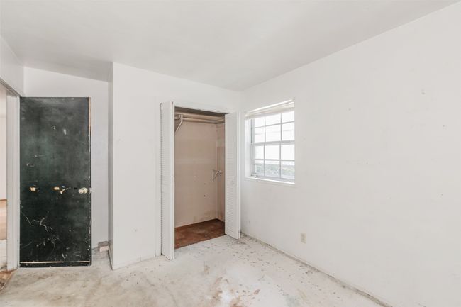 Unfurnished bedroom with unfinished concrete floors and a closet | Image 15