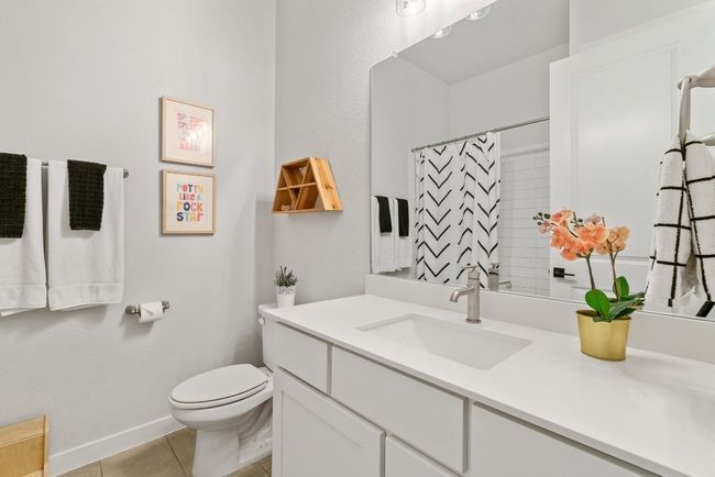 Full bath with tile patterned floors, vanity, and curtained shower | Image 28