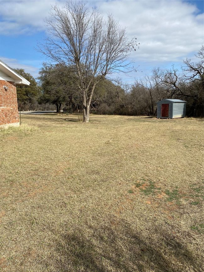 View of yard with a storage unit | Image 27