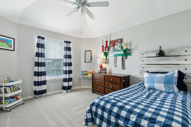 Bedroom with baseboards, a ceiling fan, and carpet flooring | Image 26