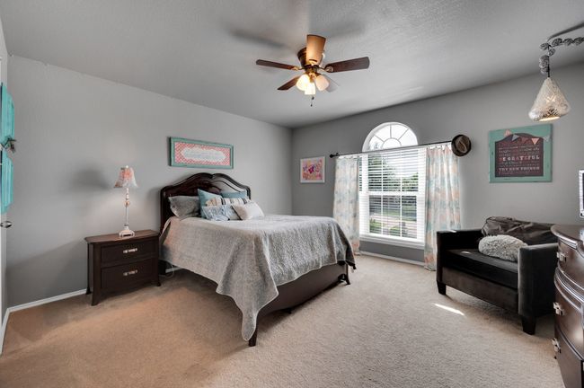 Bedroom with light colored carpet and ceiling fan | Image 25