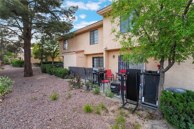Rear view of house featuring stucco siding and a patio | Image 39
