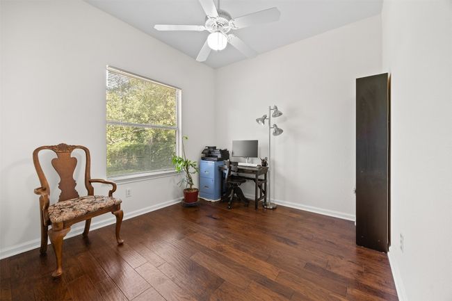 Office with wood finished floors and ceiling fan | Image 21