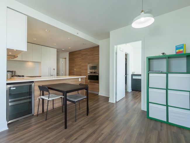 Kitchen with wine cooler, stainless steel appliances, modern cabinets, white cabinetry, and dark wood finished floors | Image 8