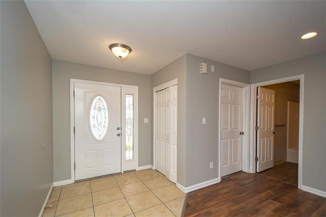 Foyer entrance featuring light tile patterned floors and baseboards | Image 4