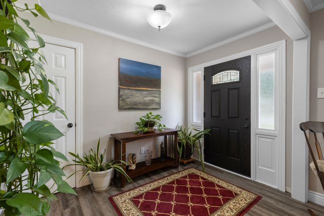 Foyer featuring wood finished floors and crown molding | Image 25