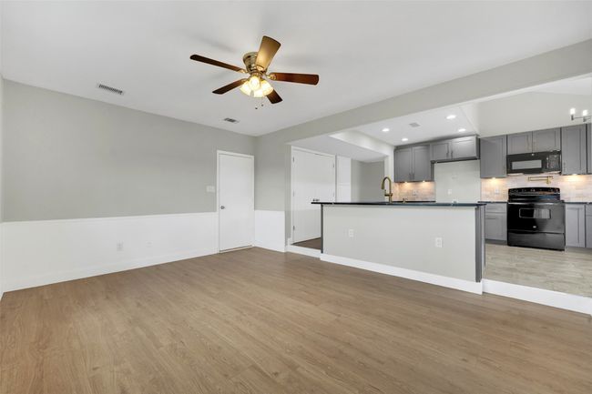 Unfurnished living room featuring ceiling fan, light wood-style floors, and recessed lighting | Image 12