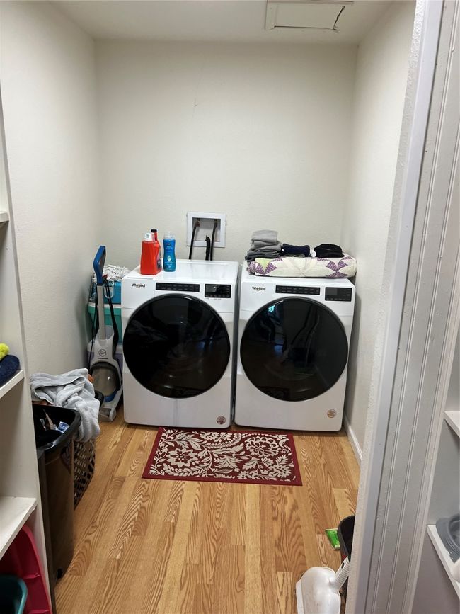 Washroom with wood finished floors and separate washer and dryer | Image 14