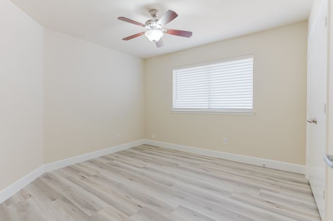 Unfurnished room featuring light wood-type flooring, ceiling fan, and baseboards | Image 20