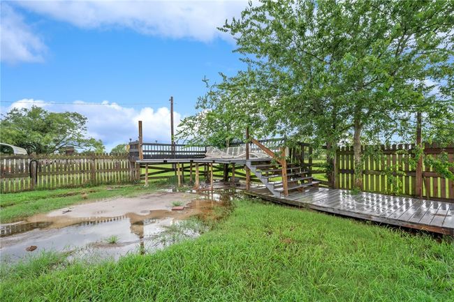 Fenced yard featuring a deck | Image 23