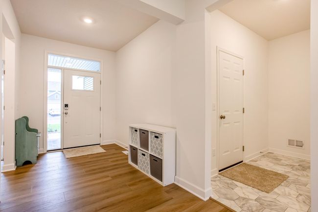 Bright front entryway featuring bright windows and stylish tilework near the garage access—perfect for daily functionality. | Image 16