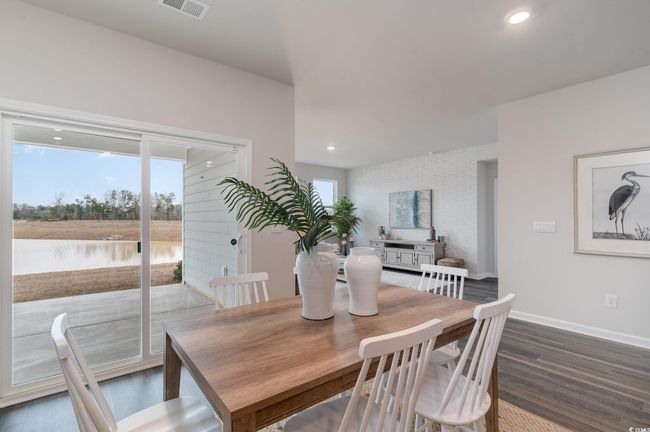 Dining room with dark wood-style floors and recessed lighting | Image 11