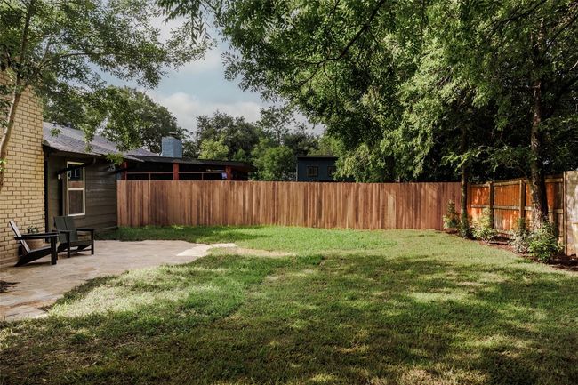 Fenced backyard with a patio | Image 33
