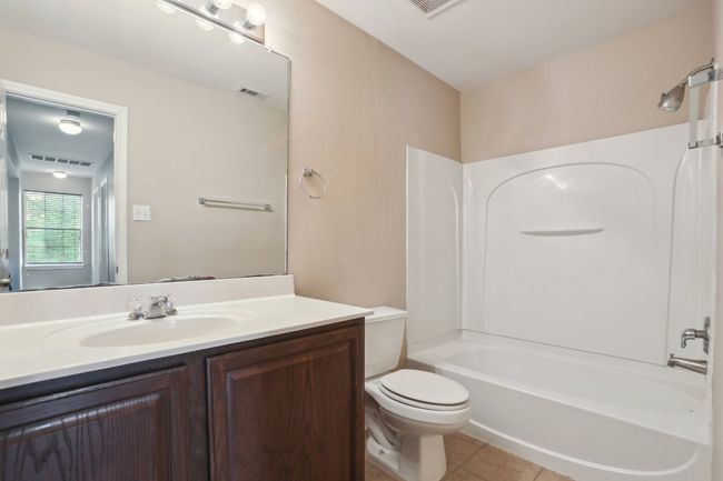 Full bath with toilet, tile patterned flooring, visible vents, and vanity | Image 29