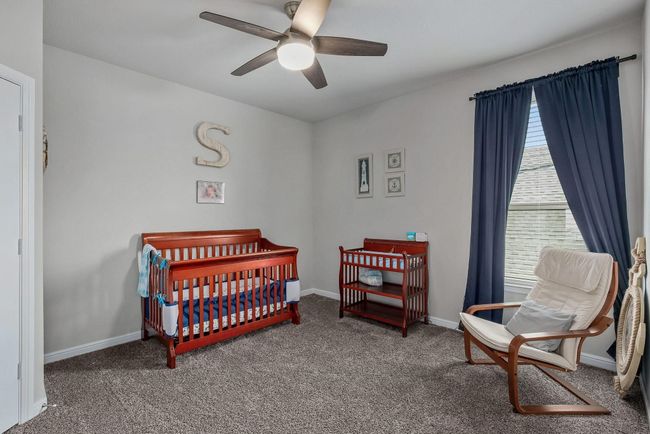 2nd bedroom with ceiling fan, baseboards, and a crib | Image 20