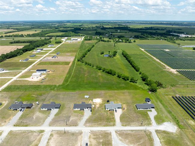 Aerial view of sparsely populated area with farmland | Image 9