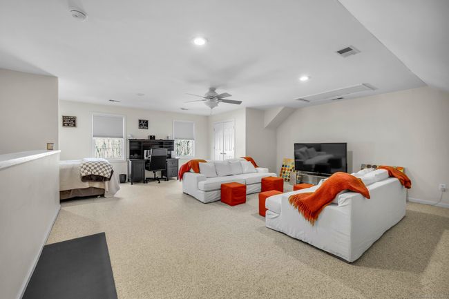 A bonus room accessed via the secondary staircase in the mudroom offers a versatile space. | Image 24
