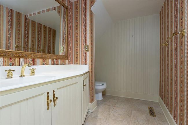 Bathroom featuring vanity, tile patterned floors, and toilet | Image 43