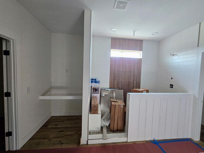 Bathroom featuring wood finished floors, radiator, and baseboards | Image 25