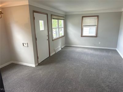 Foyer entrance featuring a healthy amount of sunlight and dark carpet | Image 3