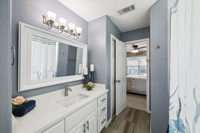 Convenient Jack and Jill bathroom connecting two first-floor bedrooms. | Image 19