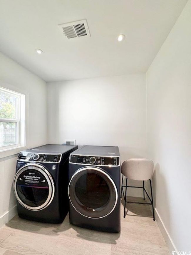 Laundry area featuring recessed lighting, washing machine and dryer, and light wood finished floors | Image 16