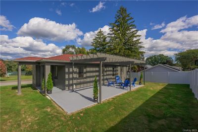 View of property's community with a patio, a lawn, and a pergola | Image 3