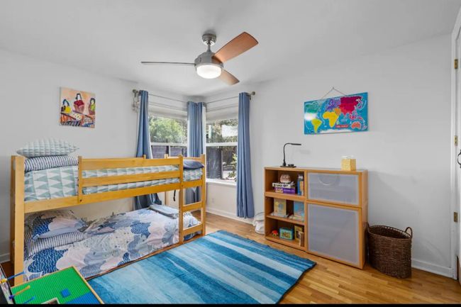 Bedroom with wood finished floors and ceiling fan | Image 14