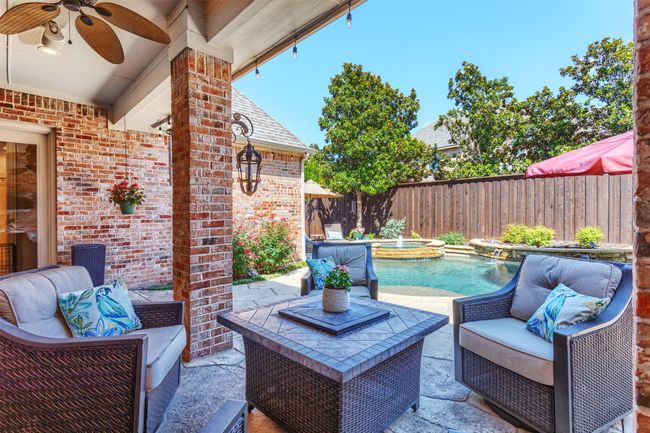 Fenced backyard featuring a ceiling fan, outdoor lounge area, a patio, and a pool with connected hot tub | Image 33