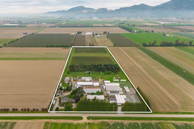 Overview of rural landscape featuring property parcel outlined, large plots for crops, and a mountain backdrop | Image 5