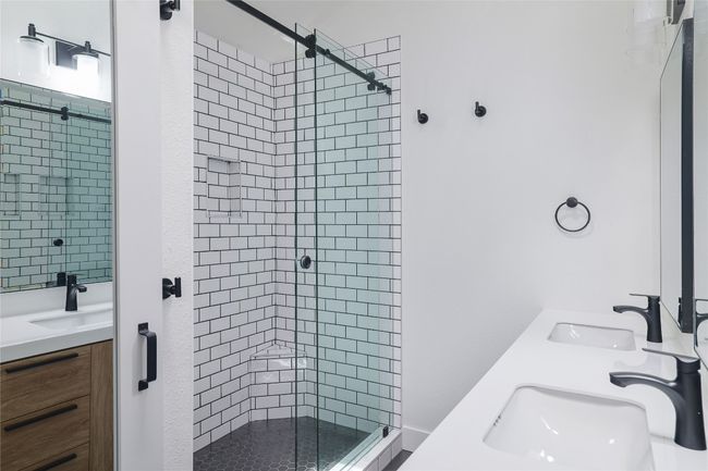 Thoughtfully designed stand-up shower with glass slider. | Image 21