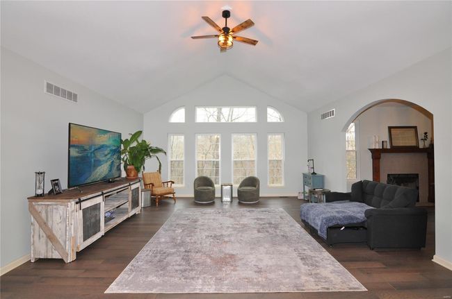 Spacious great room w/soaring ceilings and wall of windows overlooking your private wooded yard. | Image 5