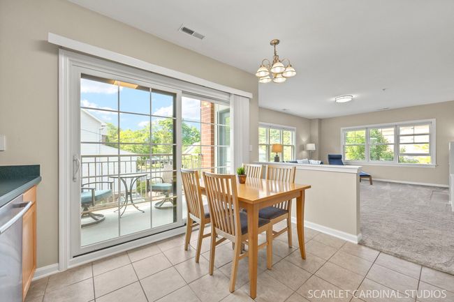 Kitchen opens up to the sunny living room. | Image 9
