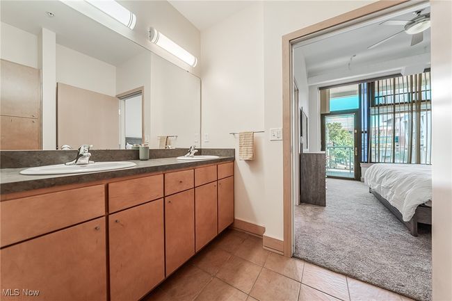 Ensuite bathroom with tile flooring, double vanity, and storage, and walk-in shower. | Image 23
