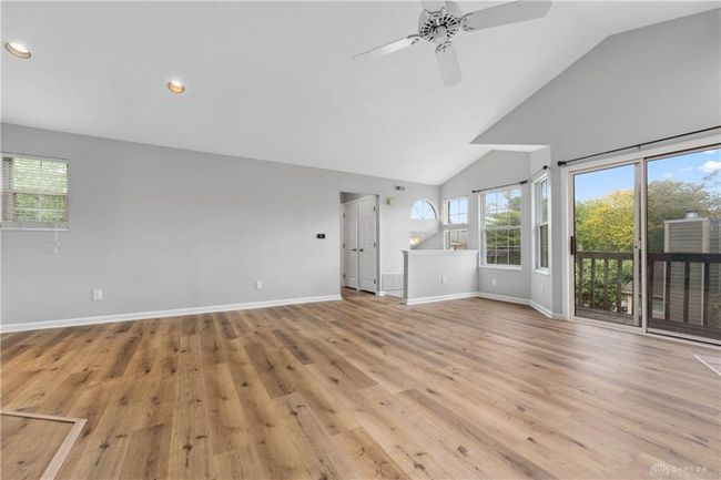 living room view of balcony and stairs | Image 6